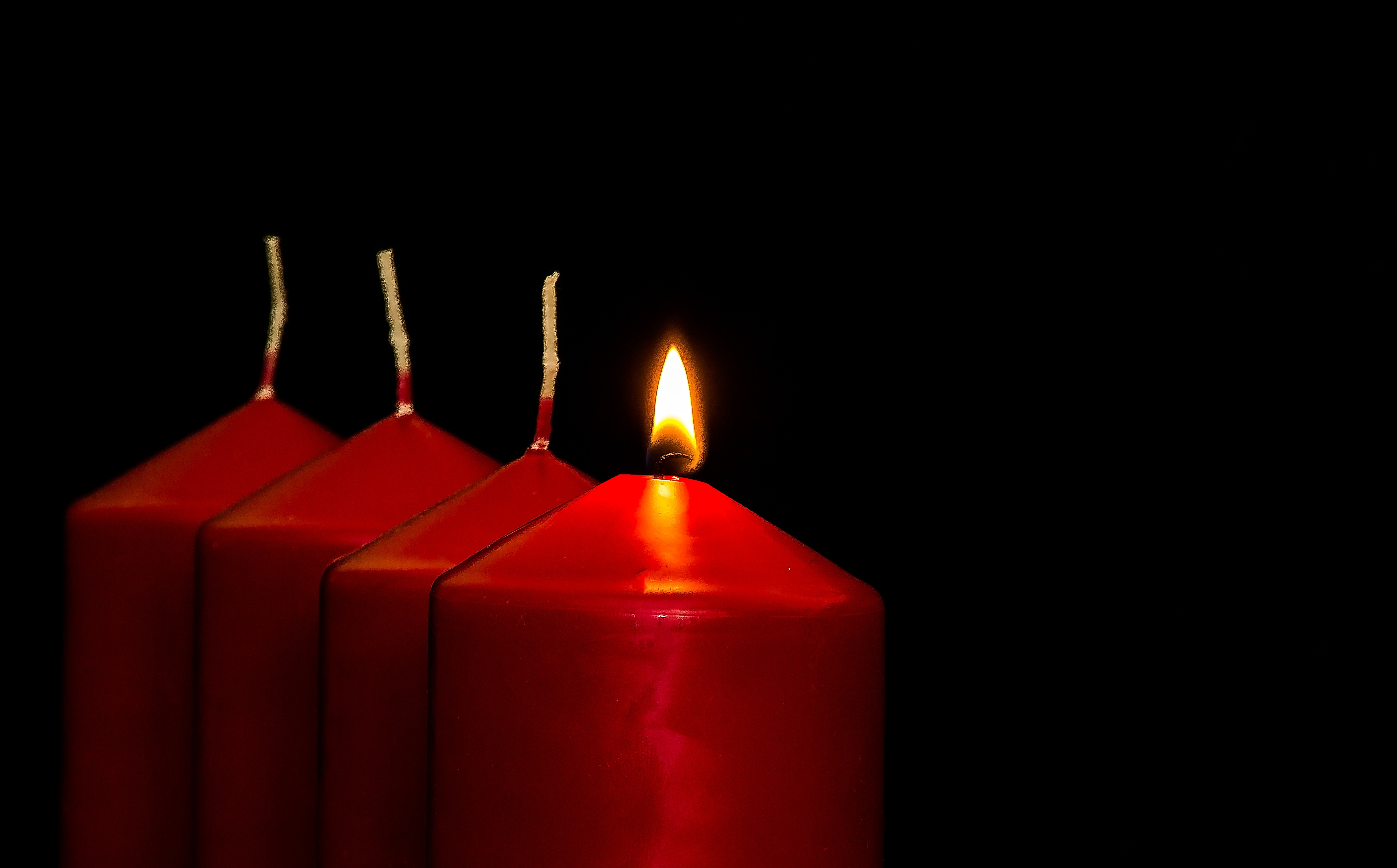 Canva - Four Lit Red Candles.jpg